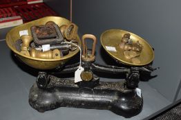 A 'Libra' cast iron weighing scale in original black paint, to include various weights, w31cm.