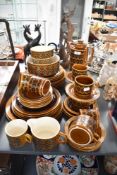 A retro Hornsea Heirloom tea service, decorated with psychedelic patterns on a brown glazed