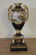 A late 19th Vienna porcelain style urn vase, mounted on a wooden block and decorated with