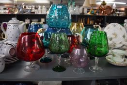 A large group of oversized brandy glasses in various colours, to include cats and mice, largest