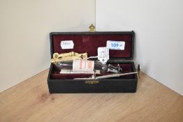 A vintage ear piercing kit, sold together with a pair of 9ct gold stud earrings weighing approx. 0.