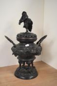 A large Meiji period Japanese bronze censor, the lid modelled as a male worrier, the central section