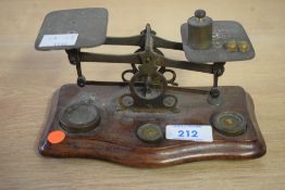 A set of early 20th century postal scales and weights, Width 17cm