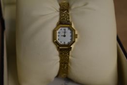 A small gold tone Rotary wristwatch, the octagonal white dial having Arabic numerals, in Rotary box