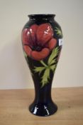 A Moorcroft pottery Anemore pattern vase, decorated with flowers on a blue ground, painted makers