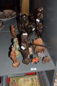 A group of African carved wooden figures, to include various elephants and a metal seated Buddha