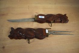 A mid / late 20th century Indian carving set, carved depicting a double headed dragon on brass