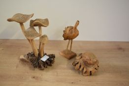 A carved wooden dart frog figure sitting on a lotus leaf, h6.5cm, sold together with a carved