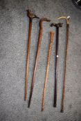 A group of vintage animal walking sticks, to include a dragon walking stick, a folk art style bird