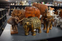 A troop of hand caved elephants, largest H36cm.
