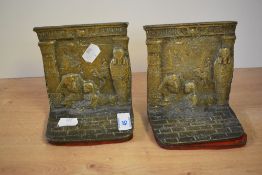 A pair of cast brass bookends decorated having Egyptian motifs, h13cm