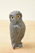 An early 20th century novelty silverplated pepperette owl, having glass eyes, h10cm