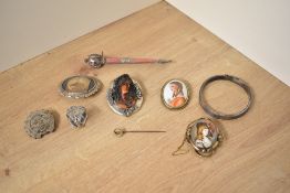 A large silver mounted cameo brooch depicting a prominent maiden in profile, along with a silver