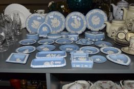 A large group of Wedgwood Jasper ware, decorated in blue and white sprigged with classical motifs,