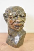 A carved irargated stone bust of an African man, h13cm Condition report: Damage to eyebrow.