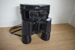 A single pair of binoculars with leather strap, factory mark '7x50 MADE IN USSR', suede lined
