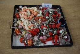 An assortment of costume jewellery, including a glass chili necklace, bracelet and ring set, glass