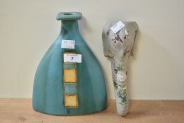A Pirjo Nylander triangular pottery vase having tiled pattern on an aqua blue ground, signature to
