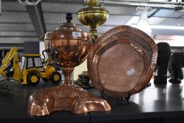 A 19th century copper and brass tea urn, having lift off lid with a black ceramic finale while
