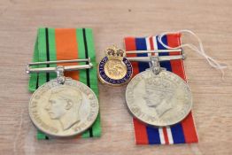 A group of medals comprising of a 1939-1945 George VI medal, a 1939-1945 defence medal and a Civil