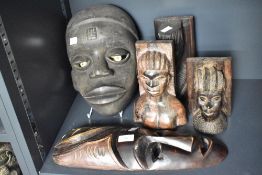 A hand carved wooden African tribal mask, having piercing white eyes, h28cm, sold together with