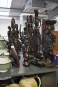 A group of hand carved wooden African tribal figures of various forms, tallest 50cm