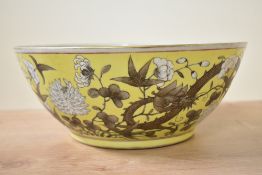 A Chinese Famille Rose Imperial yellow porcelain bowl, decorated having blossoms and butterfly's,