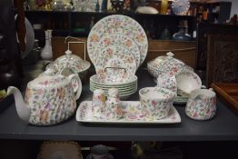 A Minton bone china Haddon Hall pattern dinner service, beautifully decorated having foliage on a