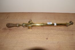 An antique brass garden sprayer, having pump action mechanism and wooden handle, L52cm