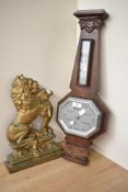 A 1940's oak barometer in the Art Deco style, having thermometer, decorated with carved floral