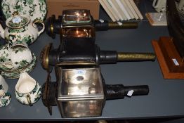 Three early 20th century coach lanterns having red glass eyes, largest L47cm