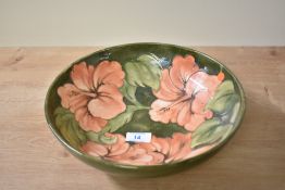 A Moorcroft pottery Hibiscus pattern fruit bowl, decorated having pink tone hibiscus motifs on a