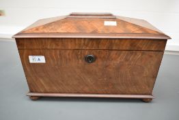 A 19th century tea caddy of sarcophagus form, supported on bun feet, the interior having two