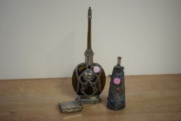 A Moroccan style perfume bottle having brown colour glass mounted in an ornate silverplated case,