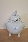 An early 20th century Chinese Blanc-de-Chine porcelain censer, having pierced lid with a Foo dog
