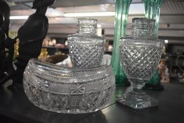 A pair of early 20th century Regency style cut glass lidded urns, having egg shaped body and