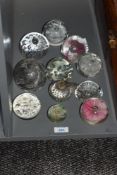 A group of transparent glass paperweights, to include an apple paperweight, flower paperweight