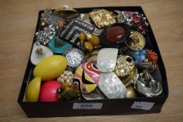 A large assortment of clip-on earrings, including faux pearl pieces, large statement earrings and