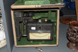 A vintage paper testing instrument in original case, plaque inside reading; instrument serial No S.