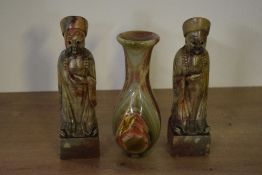 A pair of Chinese carved hard stone Confucius style figures, displayed on a square base seen