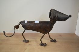 A scrap metal dog sculpture having spring neck and tail, H29cm.