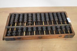 An early 20th century wooden bead abacus, possibly Japanese, 35cm.