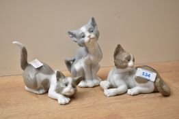 A group of three Lladro porcelain cat studies comprising 'Attentive Cat' number 5112, 'Feed Me'