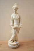 A cast composition figurine depicting a female holding a long basket flowers on marble base,