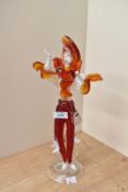 A vintage hand blown Murano glass dancer figurine in right red and orange, measuring 36cm tall.