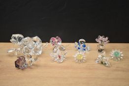 An assortment of Swarovski Crystal SCS Collection decorative flowers including roses, orchids, green