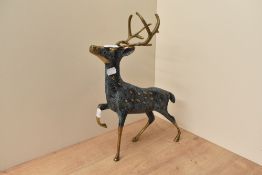 A large patinated brass stag study, measuring 40cm tall.