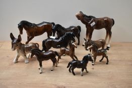 An assortment of Beswick Pottery and other horses and foals, sold together with an amateur donkey