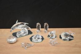 An assortment of Swarovski Crystal animal studies including Dolphins, Penguins and Whale, nine in