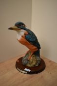 A large Leonardo Collection porcelain Kingfisher on wooden plinth, measuring 29cm tall.